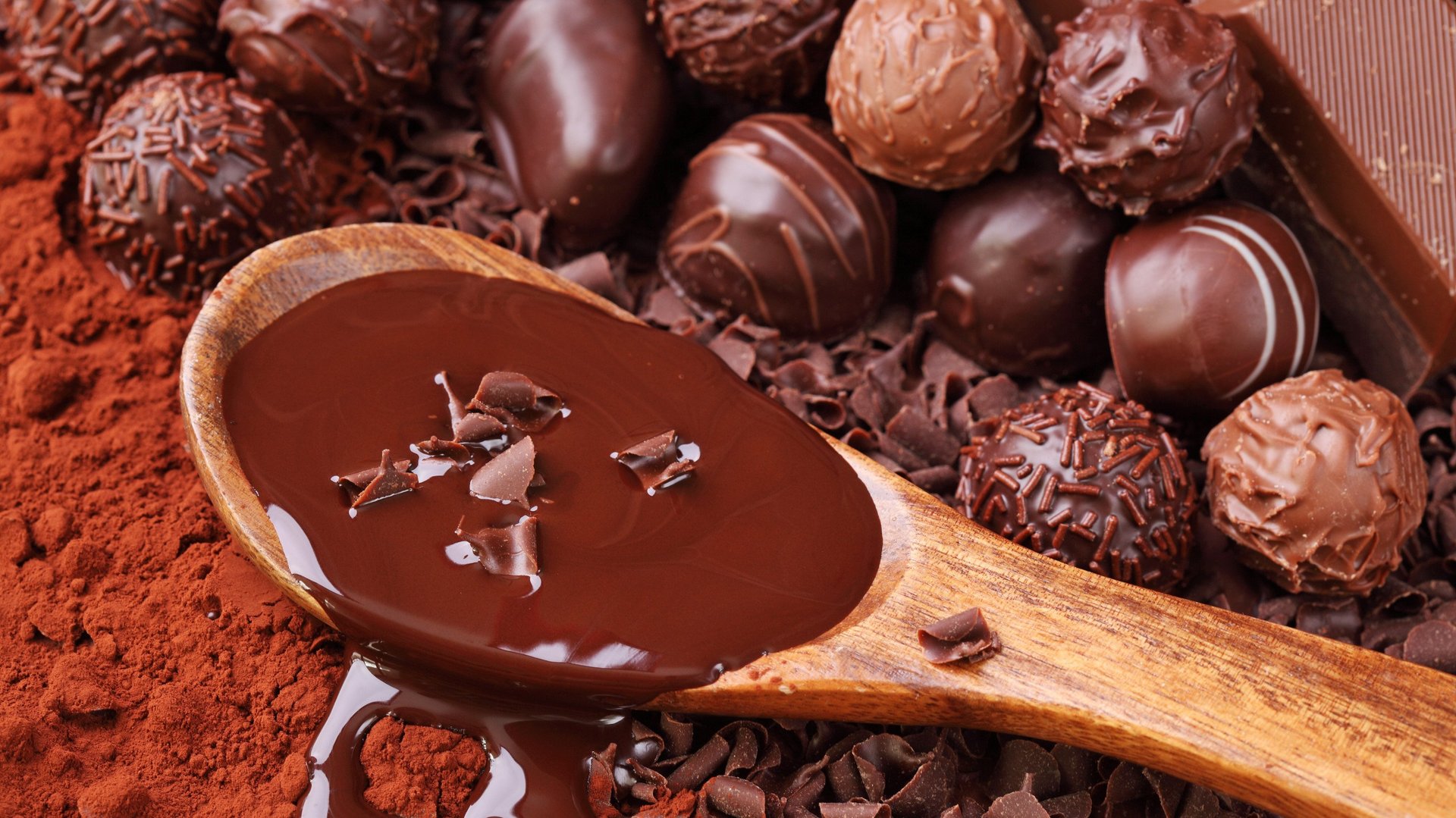 Kakaopulver, geschmolzene Schokolade und Pralinen