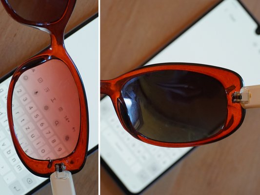 Glas einer Sonnenbrille, in verschiedenen Winkeln über weissen Handybildschirm gehalten
