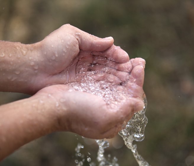 Klares Wasser in einem Paar Hände